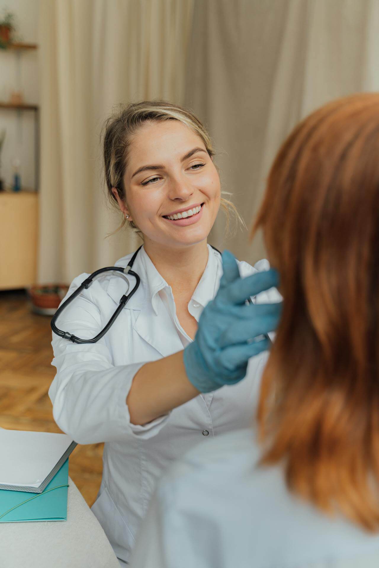 Female doctor in a white lab coat giving a comprehensive wellness evaluation.