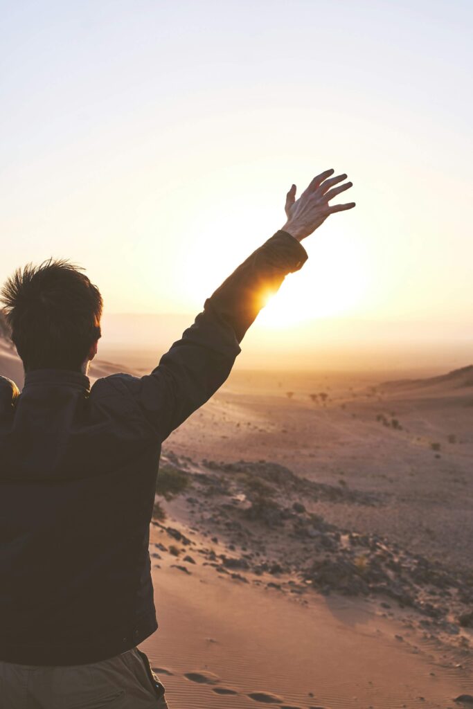 Man with arms in the air feeling good due to feeling healthy.