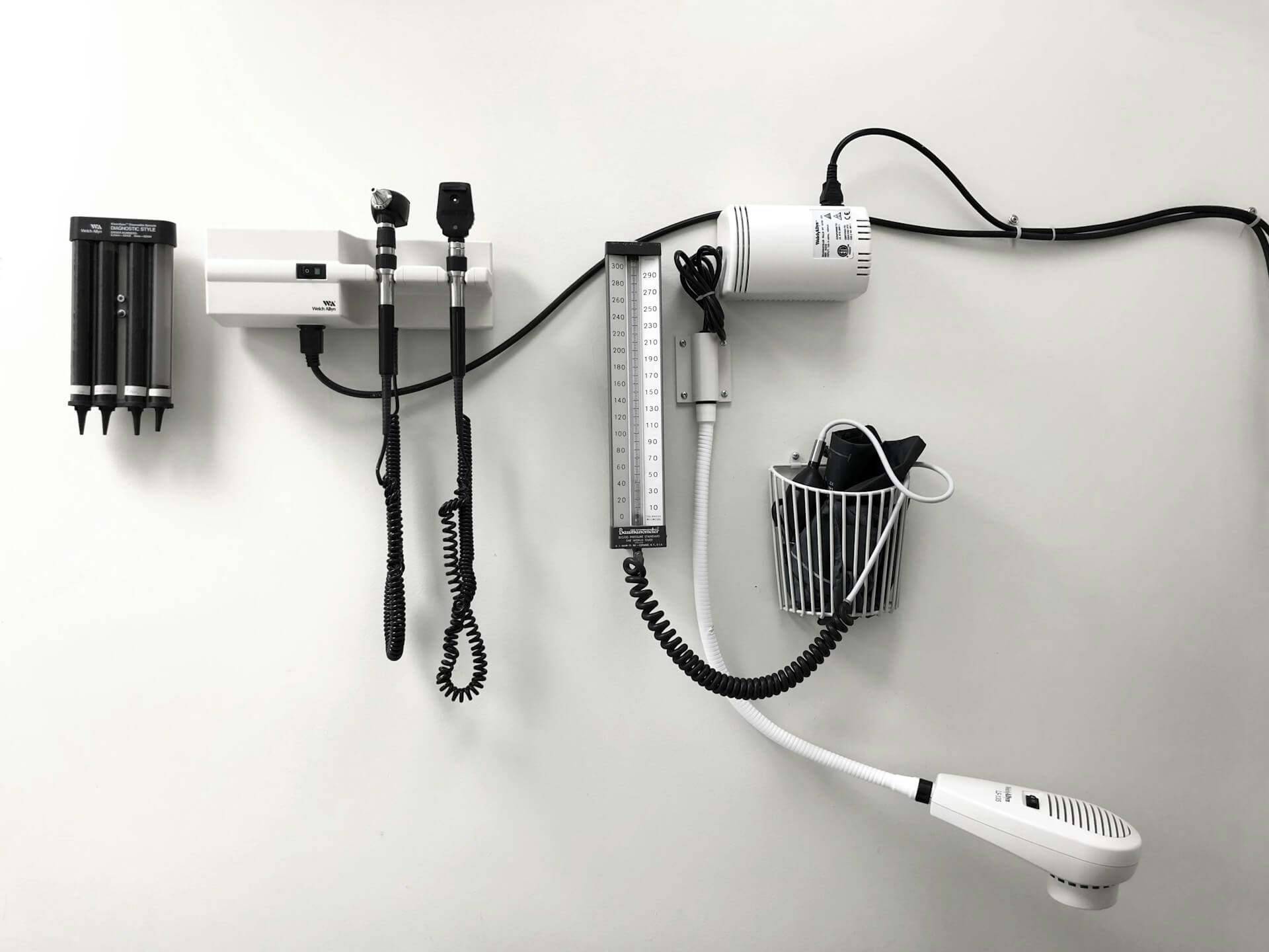 White wellness tools hanging on a white all in urgent care room.