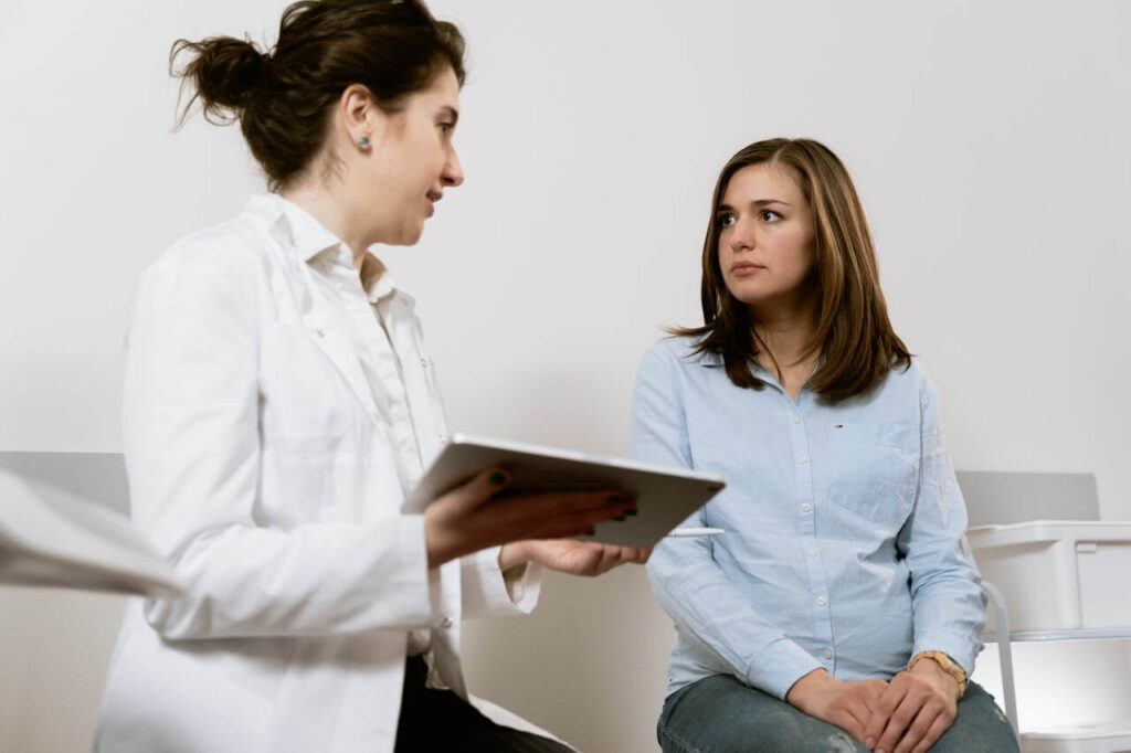 Female doctor working with a female patient during a free consultation.